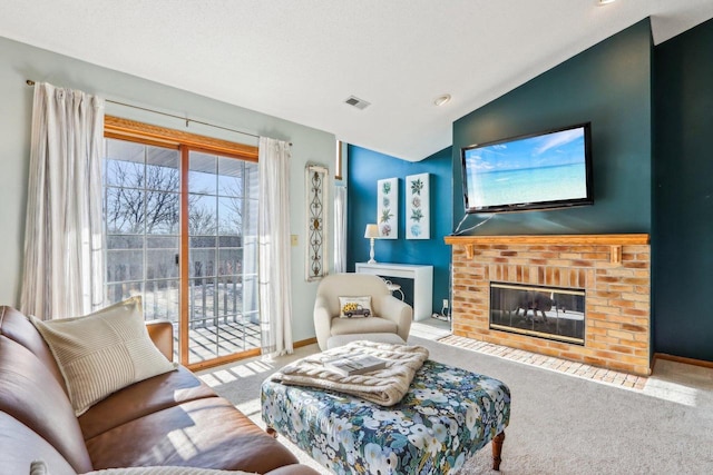 living room featuring a brick fireplace, carpet floors, and vaulted ceiling