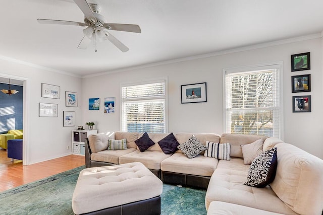 living room with ceiling fan, crown molding, a healthy amount of sunlight, and hardwood / wood-style floors