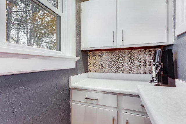 kitchen with white cabinets and backsplash