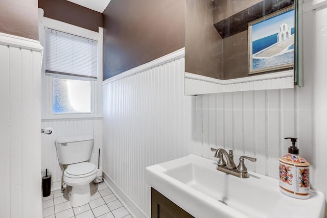 bathroom with toilet, tile patterned flooring, and vanity