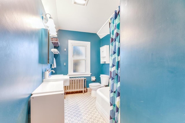 bathroom with radiator, vanity, and toilet