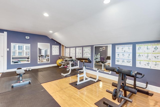 workout area featuring lofted ceiling and hardwood / wood-style flooring