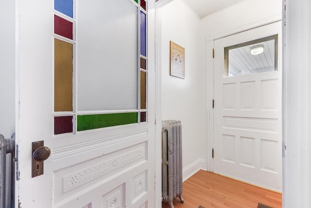 entryway featuring radiator heating unit and hardwood / wood-style flooring