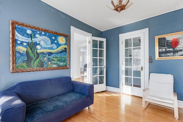 sitting room with french doors and wood-type flooring