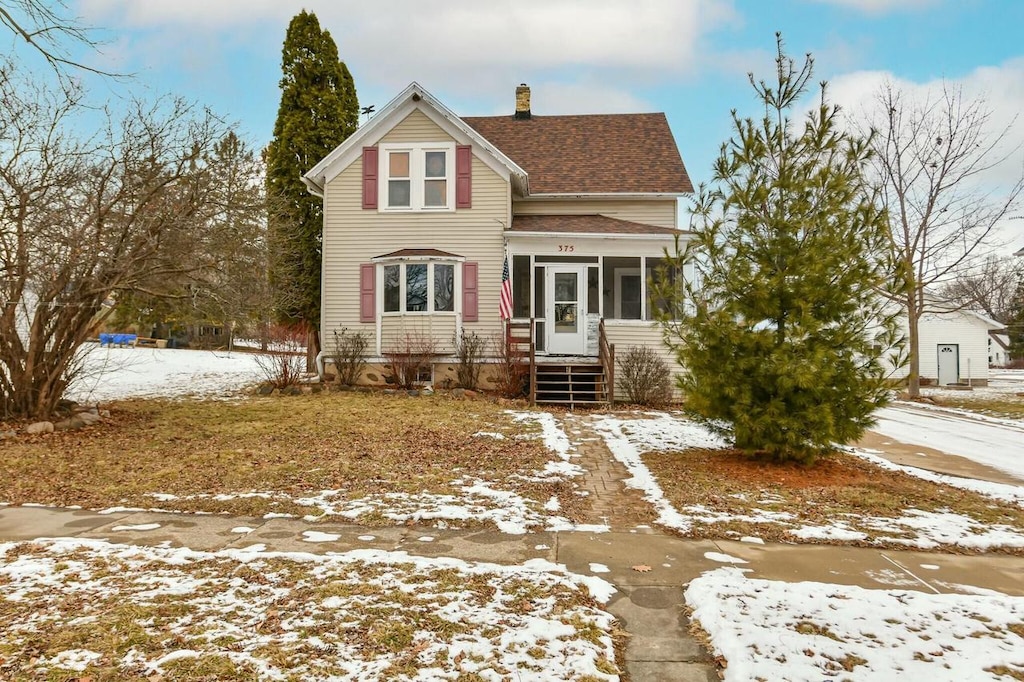 view of front of home with a sunroom