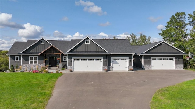 craftsman-style home featuring a front yard and a garage