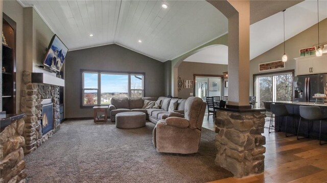 E5695 510th Ave, Menomonie, WI 54751 - living room featuring plenty of natural light, dark hardwood / wood-style floors, wood ceiling, and a stone fireplace
