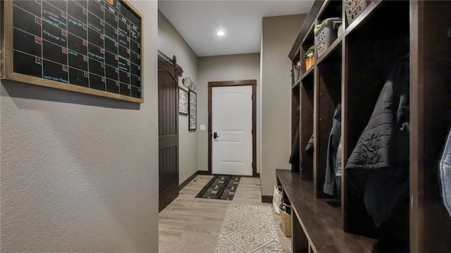 E5695 510th Ave, Menomonie, WI 54751 - mudroom featuring light hardwood / wood-style floors and a barn door