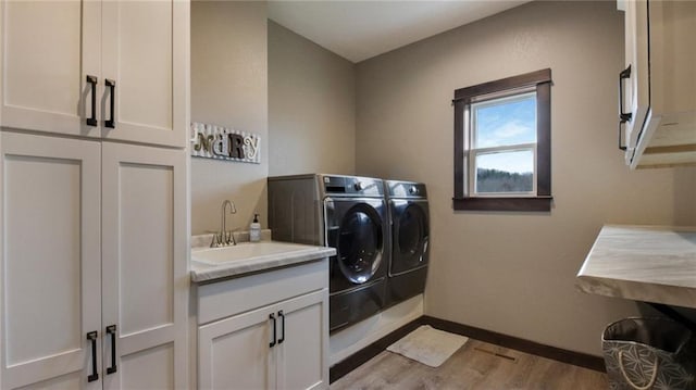 E5695 510th Ave, Menomonie, WI 54751 - washroom with washer and dryer, sink, light hardwood / wood-style floors, and cabinets