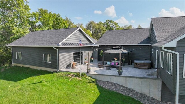 E5695 510th Ave, Menomonie, WI 54751 - back of house with a lawn, a hot tub, and a patio area