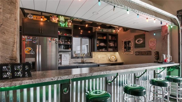 E5695 510th Ave, Menomonie, WI 54751 - bar with sink, decorative backsplash, and stainless steel fridge with ice dispenser