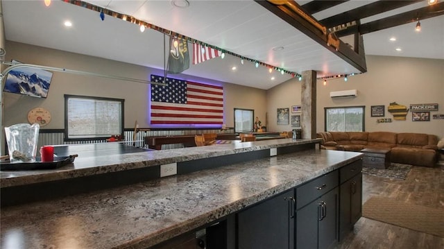 E5695 510th Ave, Menomonie, WI 54751 - kitchen with dark stone counters, a wall unit AC, lofted ceiling, and dark hardwood / wood-style floors