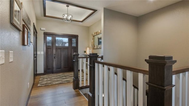 E5695 510th Ave, Menomonie, WI 54751 - entrance foyer featuring a raised ceiling, a chandelier, and hardwood / wood-style floors