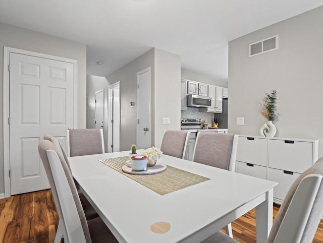 dining room with dark wood-type flooring