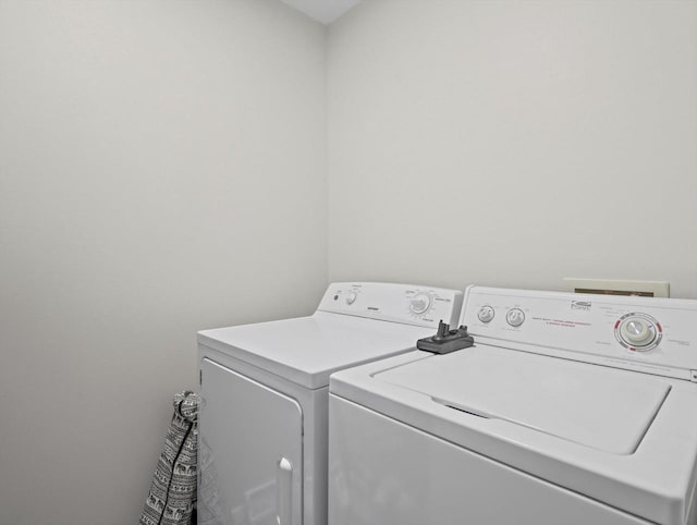 clothes washing area with washing machine and clothes dryer