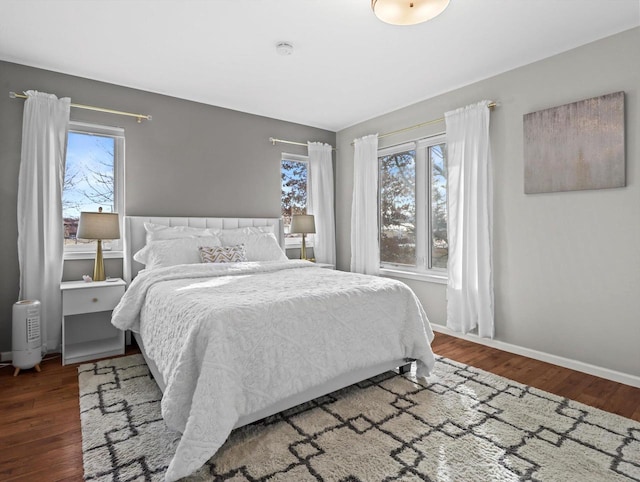 bedroom featuring multiple windows and hardwood / wood-style floors