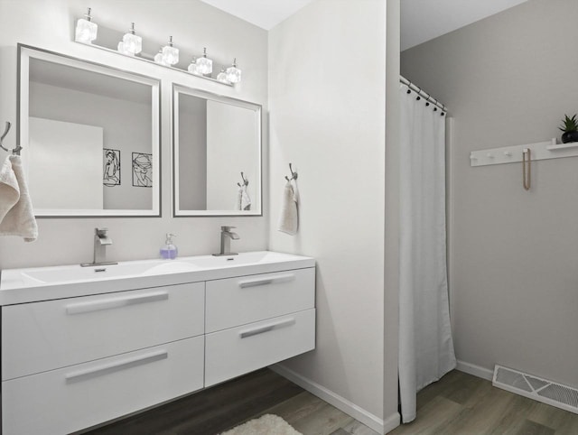 bathroom featuring vanity and hardwood / wood-style floors