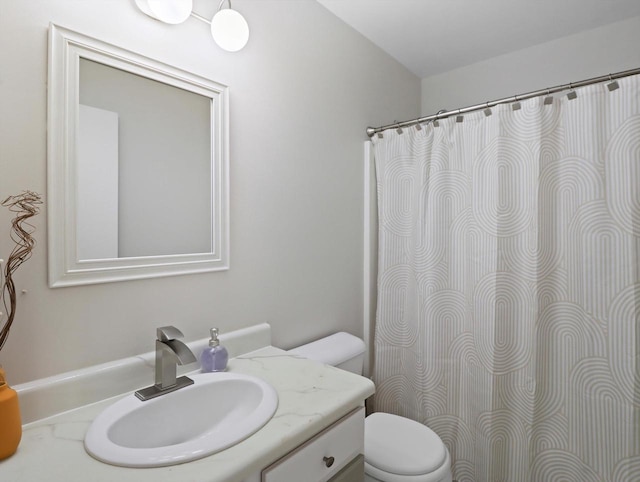 bathroom featuring toilet and vanity