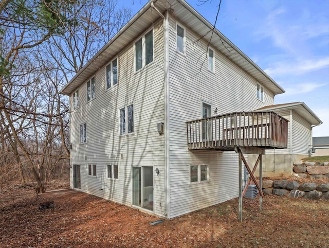 rear view of house featuring a wooden deck