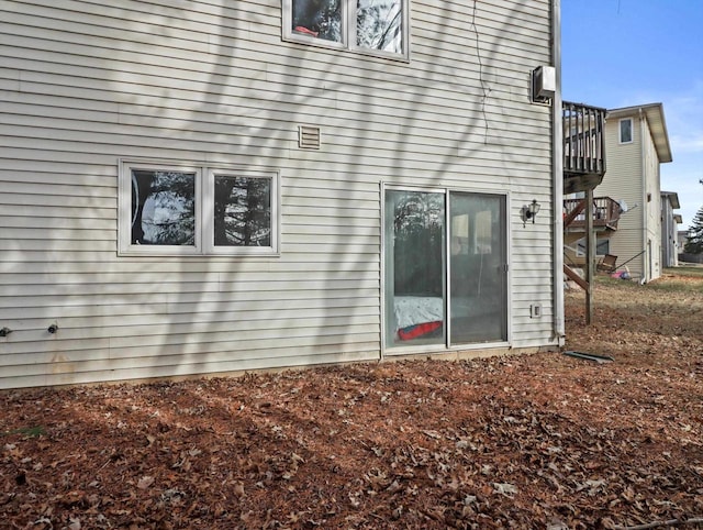 view of side of home featuring a balcony