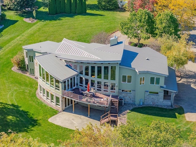 back of house featuring central AC unit, a yard, and a wooden deck