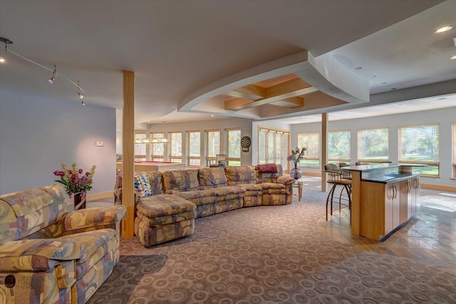 living room featuring coffered ceiling and beam ceiling