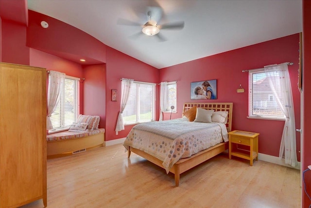 bedroom featuring lofted ceiling, ceiling fan, and light hardwood / wood-style flooring