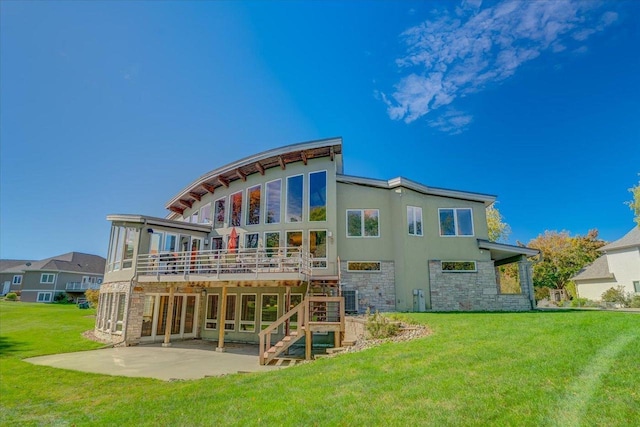 rear view of property with a patio, a deck, central air condition unit, and a lawn