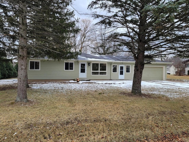 single story home with a front yard and a garage