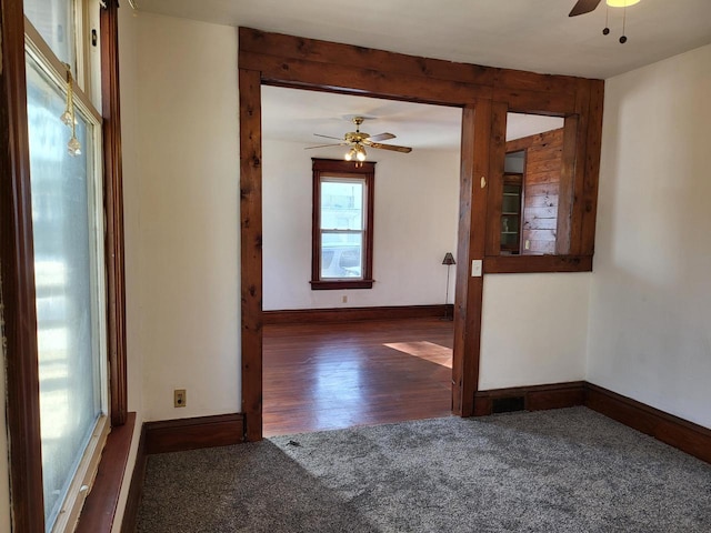 carpeted spare room featuring ceiling fan