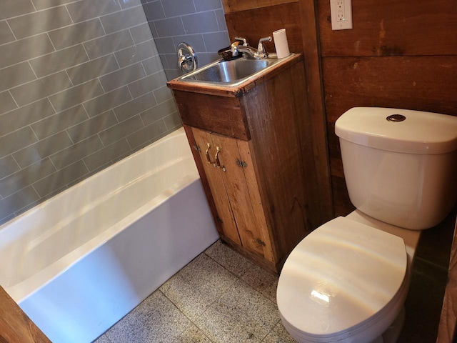 bathroom with toilet, vanity, and a tub to relax in