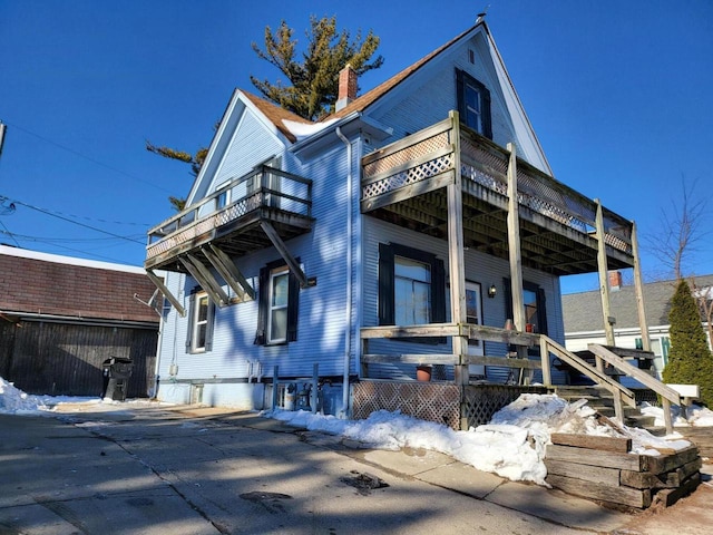 view of side of home featuring a balcony