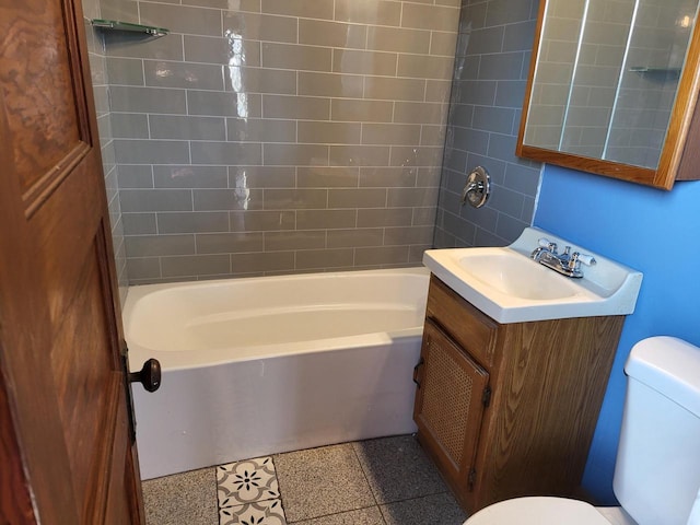 full bathroom with toilet, vanity, and tiled shower / bath