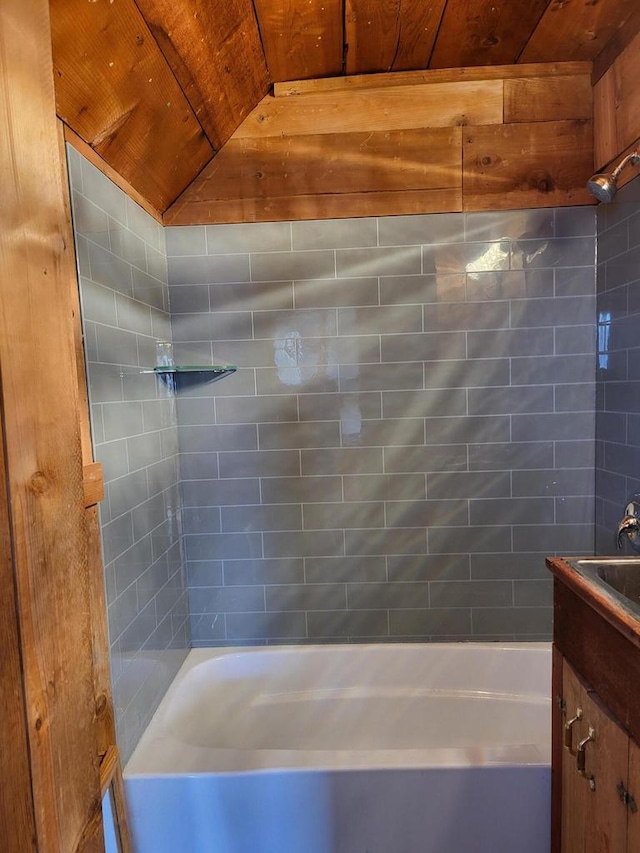 bathroom featuring tiled shower / bath and vanity