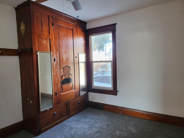 interior space with carpet floors and ceiling fan