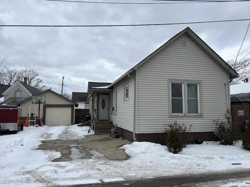 view of front of property featuring a garage and an outbuilding