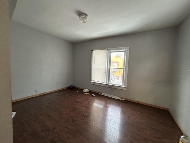 unfurnished room with dark wood-type flooring