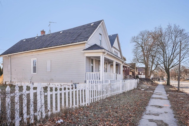 view of side of home with covered porch