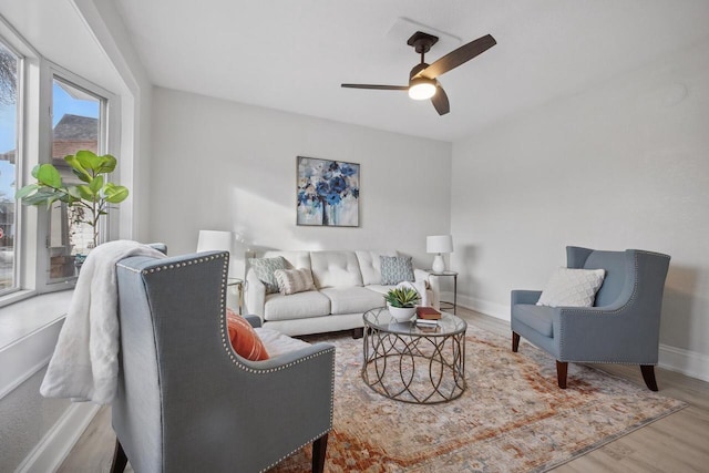 living room featuring ceiling fan and hardwood / wood-style flooring