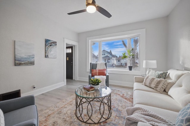 living room featuring light wood-type flooring and ceiling fan