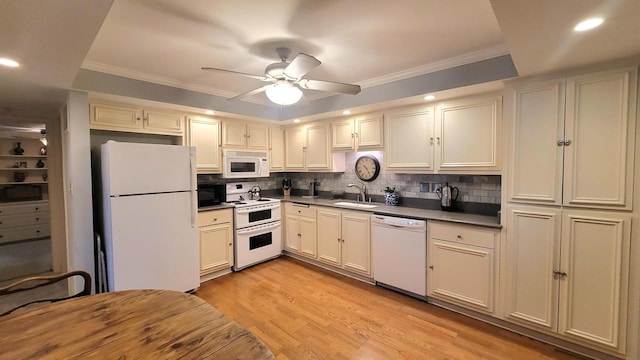 kitchen featuring white appliances, ceiling fan, decorative backsplash, sink, and light hardwood / wood-style flooring