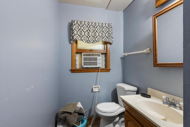 bathroom featuring toilet, cooling unit, vanity, and tile patterned floors