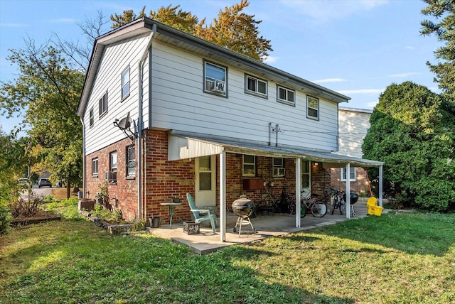 rear view of house with a patio and a yard