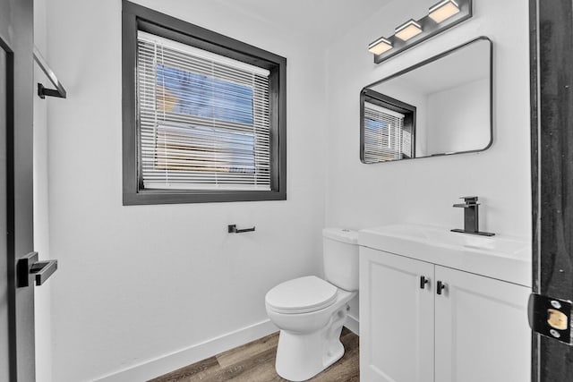 bathroom featuring hardwood / wood-style floors, toilet, and vanity