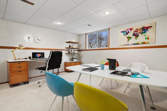 carpeted office with a drop ceiling