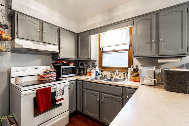 kitchen featuring sink, gray cabinetry, and electric stove