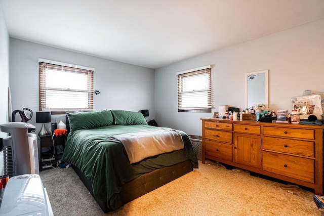 bedroom with light colored carpet