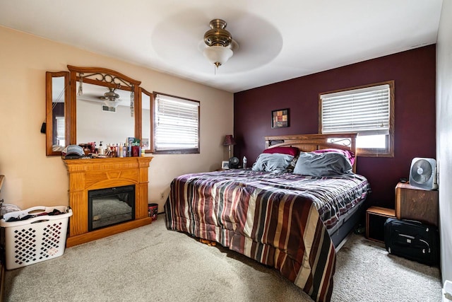 bedroom with ceiling fan and light carpet