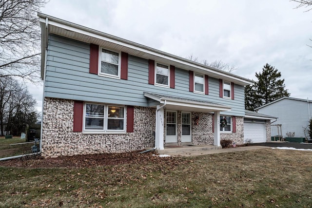 front of property featuring a front yard, a garage, and a porch