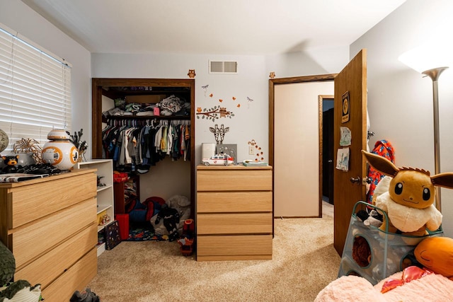 bedroom featuring a closet and light carpet